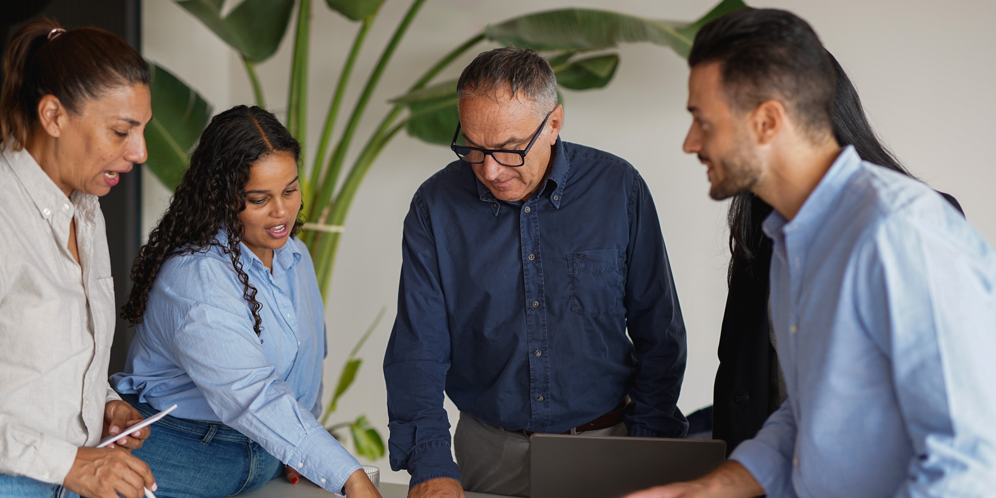 Multiracial business people working together inside modern office sharing ideas